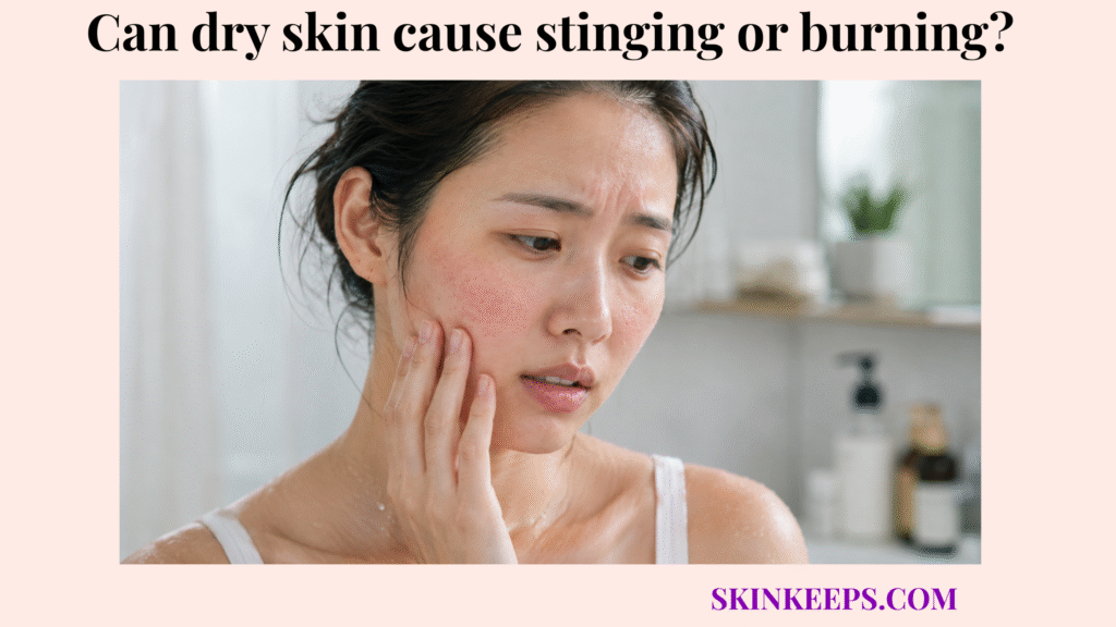 Woman touching a reddened cheek in a bathroom, showing skin discomfort linked to dry skin stinging or burning.