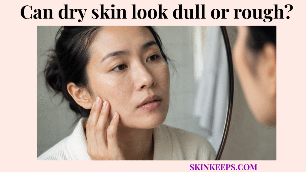 Person examining dull, rough-looking dry facial skin in a bathroom mirror